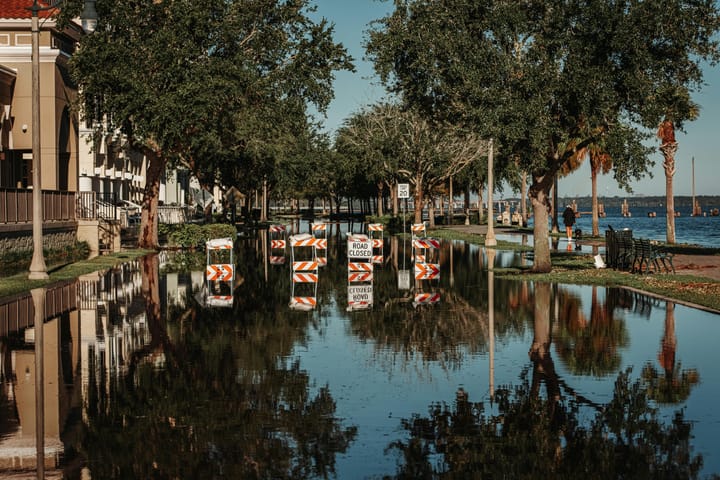 a flooded street with road closed signs